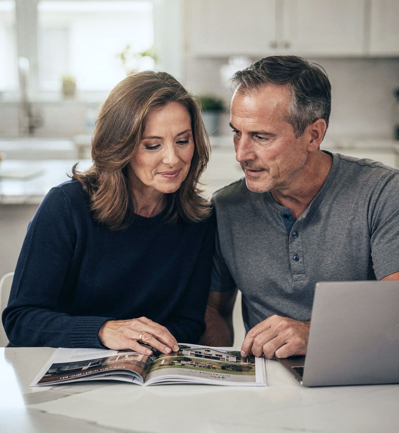 A family at their kitchen table after a tour, going through a senior living community's brochure